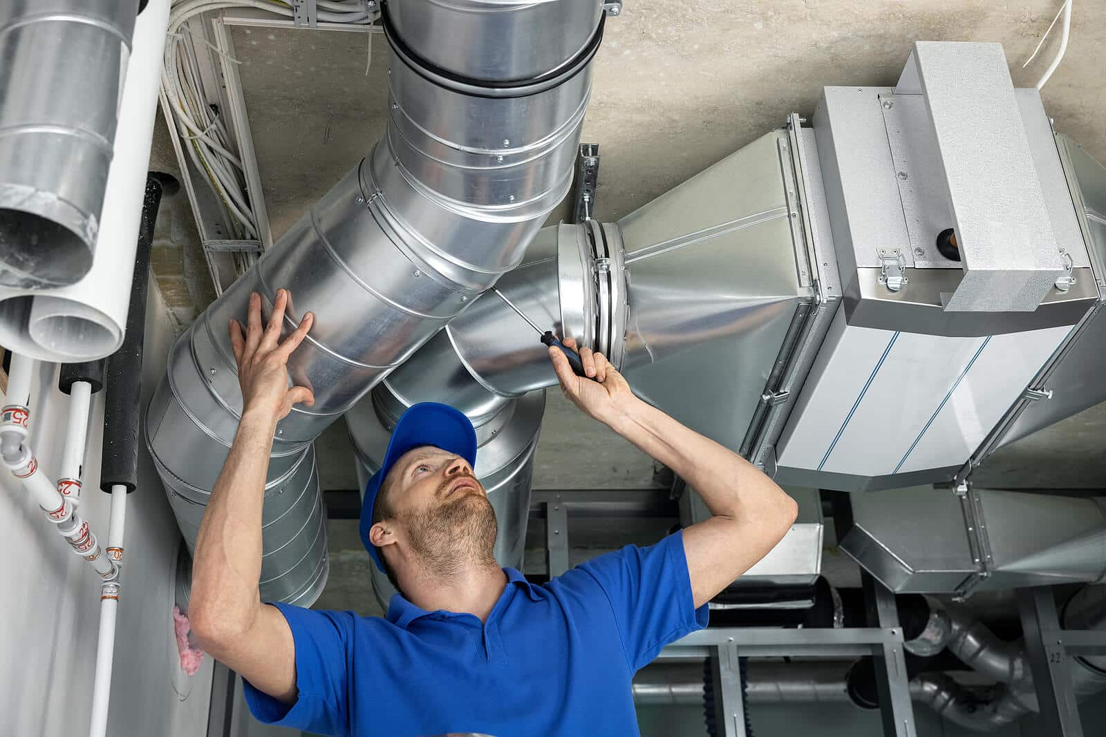HVAC technician inspecting and repairing air ducts in Thousand Oaks