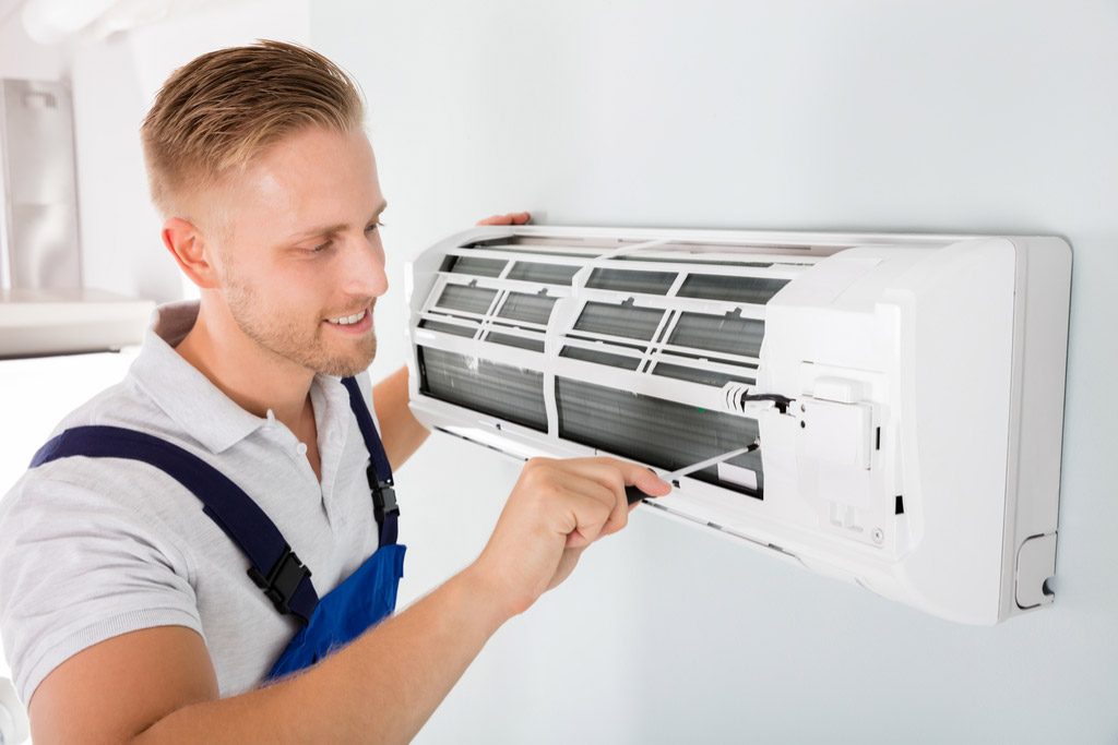 HVAC technician maintaining a ductless air conditioner in Thousand Oaks