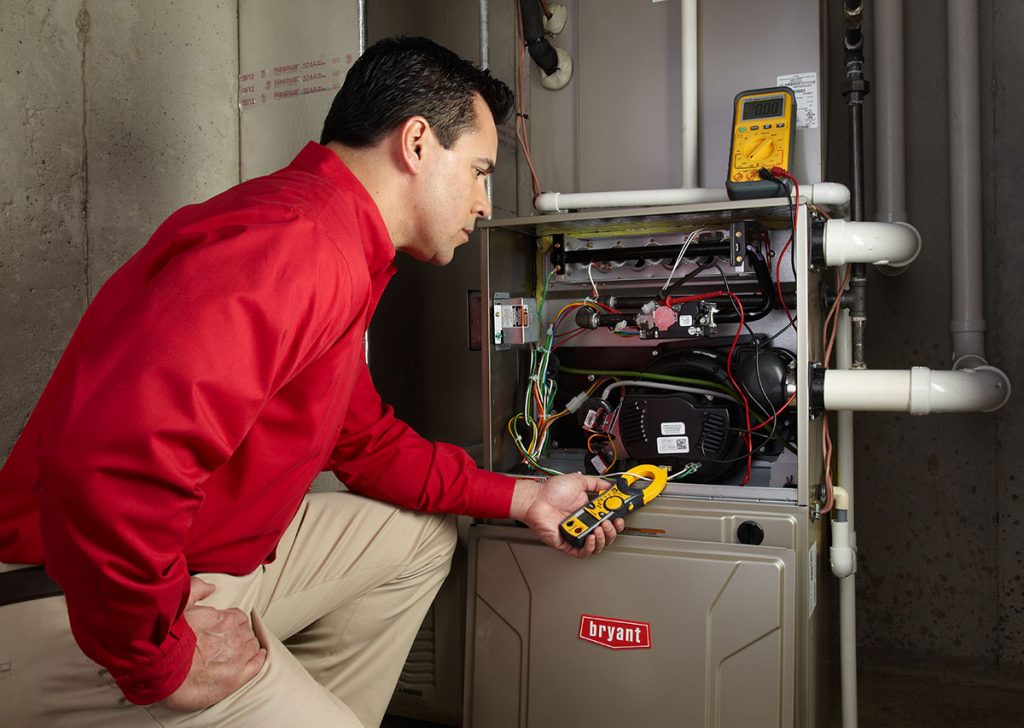 Heating technician diagnosing a furnace repair in Thousand Oaks