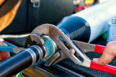Technician repairing an industrial pipe connection in Thousand Oaks