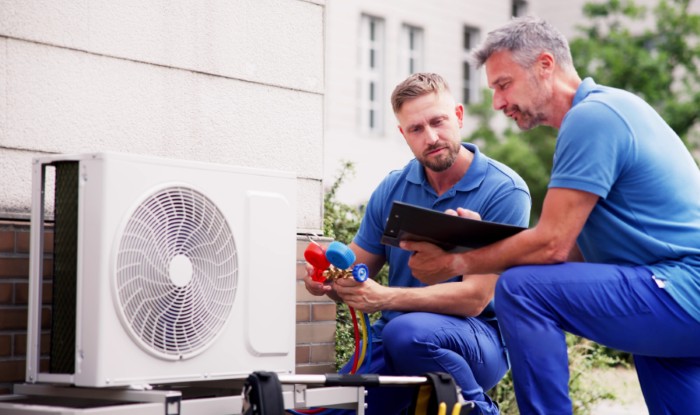 HVAC technicians installing an outdoor air conditioning unit in Thousand Oaks