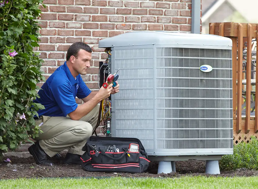 HVAC technician inspecting an outdoor AC unit in Thousand Oaks