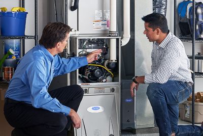 Furnace Repair or Replacement Thousand Oaks Technician evaluating a furnace for repair or replacement in Thousand Oaks
